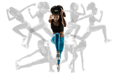 Image showing Young african woman running or jogging isolated on blue studio background.