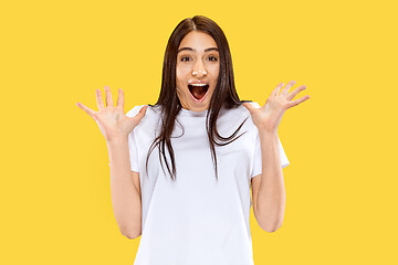 Image showing Portrait of beautiful woman isolated on yellow studio background