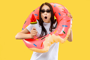 Image showing Portrait of beautiful woman isolated on yellow studio background