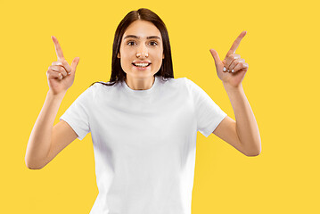 Image showing Portrait of beautiful woman isolated on yellow studio background