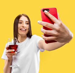 Image showing Portrait of beautiful woman isolated on yellow studio background