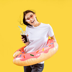 Image showing Portrait of beautiful woman isolated on yellow studio background