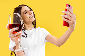 Image showing Portrait of beautiful woman isolated on yellow studio background