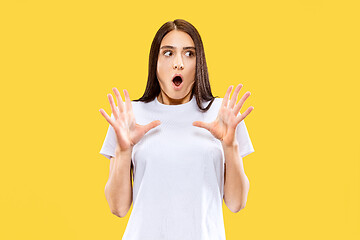 Image showing Portrait of beautiful woman isolated on yellow studio background