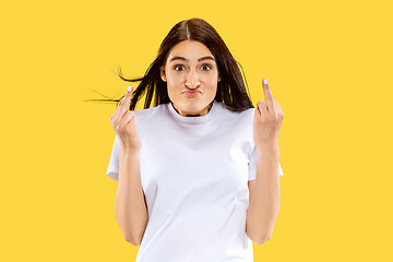 Image showing Portrait of beautiful woman isolated on yellow studio background