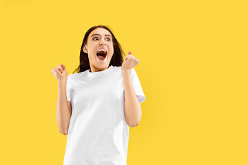 Image showing Portrait of beautiful woman isolated on yellow studio background