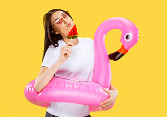 Image showing Portrait of beautiful woman isolated on yellow studio background