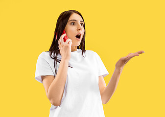 Image showing Portrait of beautiful woman isolated on yellow studio background