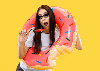 Image showing Portrait of beautiful woman isolated on yellow studio background