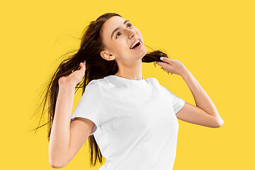 Image showing Portrait of beautiful woman isolated on yellow studio background