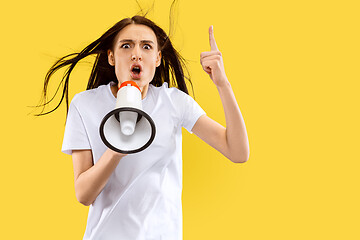 Image showing Portrait of beautiful woman isolated on yellow studio background