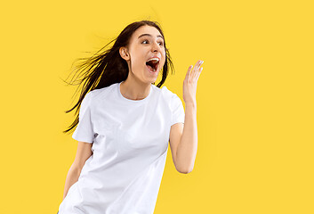 Image showing Portrait of beautiful woman isolated on yellow studio background