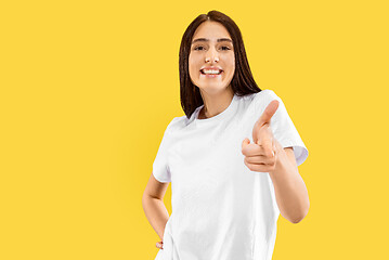 Image showing Portrait of beautiful woman isolated on yellow studio background