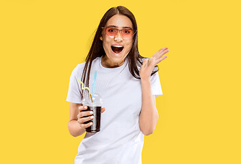 Image showing Portrait of beautiful woman isolated on yellow studio background