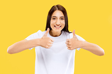 Image showing Portrait of beautiful woman isolated on yellow studio background