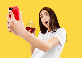 Image showing Portrait of beautiful woman isolated on yellow studio background