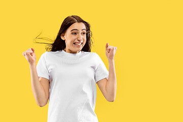 Image showing Portrait of beautiful woman isolated on yellow studio background