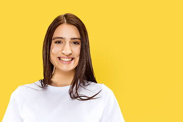 Image showing Portrait of beautiful woman isolated on yellow studio background