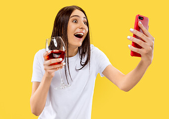 Image showing Portrait of beautiful woman isolated on yellow studio background