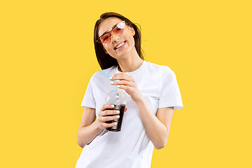 Image showing Portrait of beautiful woman isolated on yellow studio background