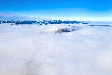 Image showing Flying drone over low clouds