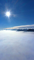 Image showing Morning sun over low clouds