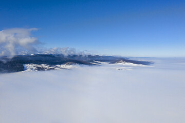 Image showing Flying drone above misty valley