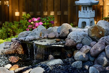 Image showing traditional Japanese garden with a stone pagoda and a waterfall