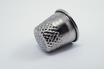 Image showing old metal tailor thimbles on a white 