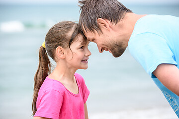 Image showing Happy dad and daughter are butting heads cheerfully