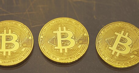 Image showing Physical shiny bitcoin agains dark background