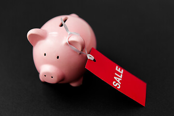 Image showing piggy bank with red sale tag on black