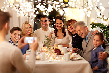 Image showing family having tea party and photographing at home