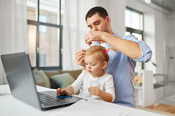 Image showing working father with baby daughter at home office