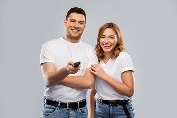 Image showing happy couple with tv remote control