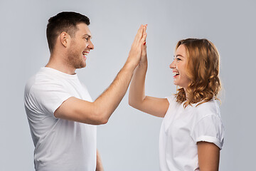 Image showing happy couple making high five gesture