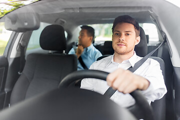 Image showing male driver driving car with passenger