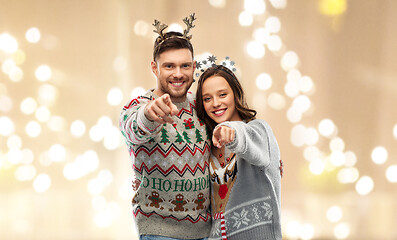 Image showing happy couple at christmas ugly sweater party