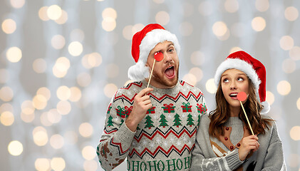 Image showing couple with christmas party props in ugly sweaters