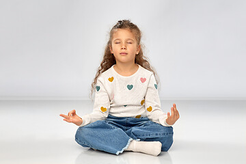 Image showing little girl in yoga lotus pose and meditating