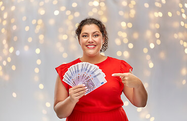 Image showing happy woman showing euro money banknotes