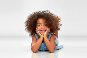 Image showing happy little african american girl lying on floor