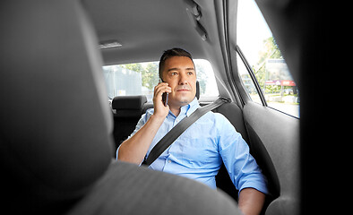 Image showing male passenger calling on smartphone in taxi car