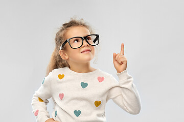 Image showing portrait of girl in glasses pointing finger up