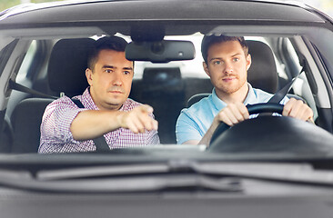 Image showing car driving school instructor teaching male driver