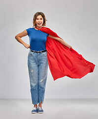 Image showing happy woman in red superhero cape