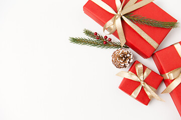 Image showing christmas gifts and fir branches with pine cones