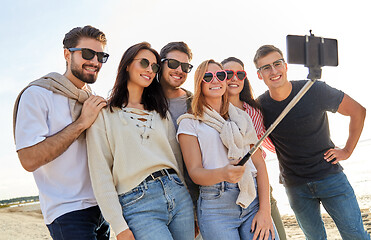 Image showing happy friends taking selfie on summer beach