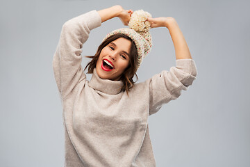 Image showing young woman in knitted winter hat and sweater