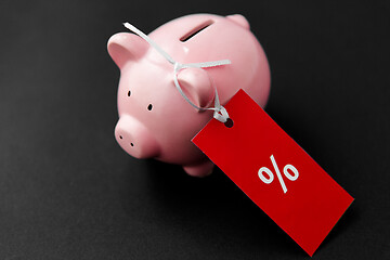 Image showing piggy bank with red sale tag on black